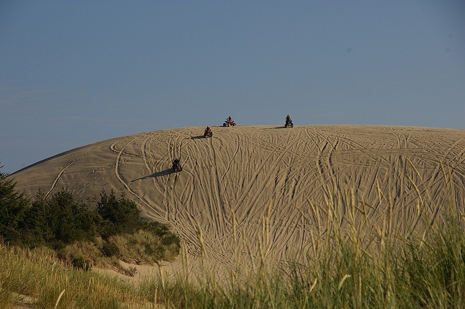 Riders on the ridgeline of the Oregon Dunes at Hauser
